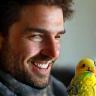 Daniel Hughes with Peanut the budgie